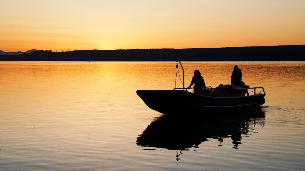 A photo of a oyster boat on the Hood Canal at sunrise.
