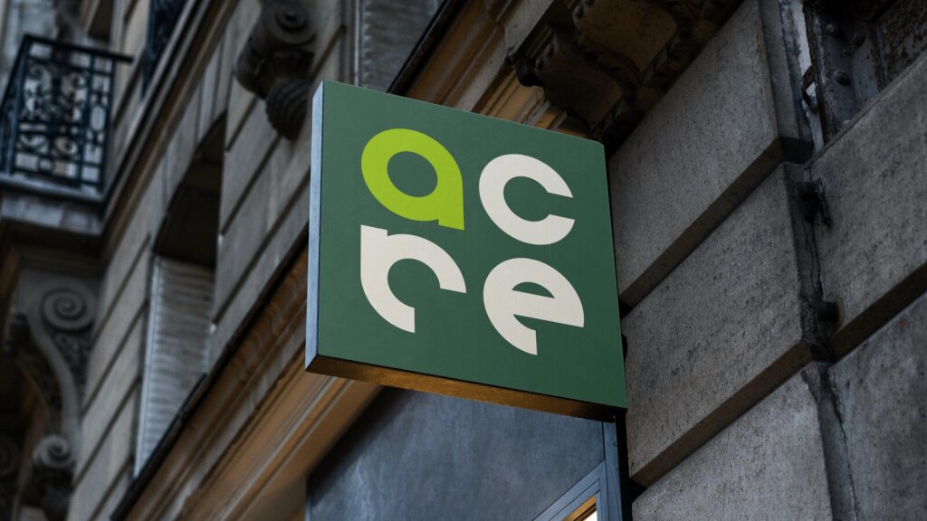 Exterior signage on the side of a building for Acre.