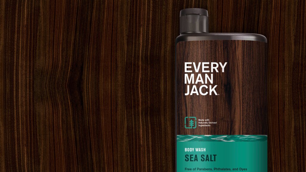 An image of a bottle of Every Man Jack Body Wash on top of a wood grain background.